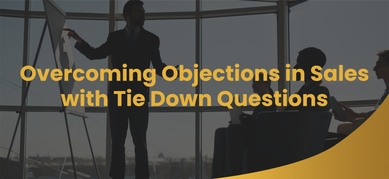 Man overcoming objections in sales standing in front of a group of prospects in a conference room.