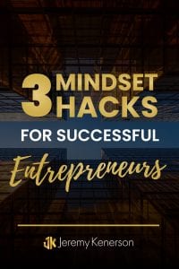 Tall buildings downtown at night with 3 Mindset Hacks for Successful Entrepreneurs in the middle.